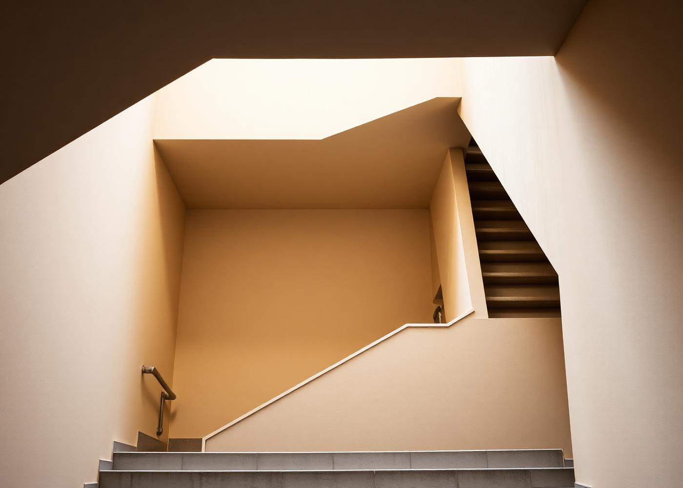 Geometric concrete stairwell photographed from below, an abstract image of structured construction
